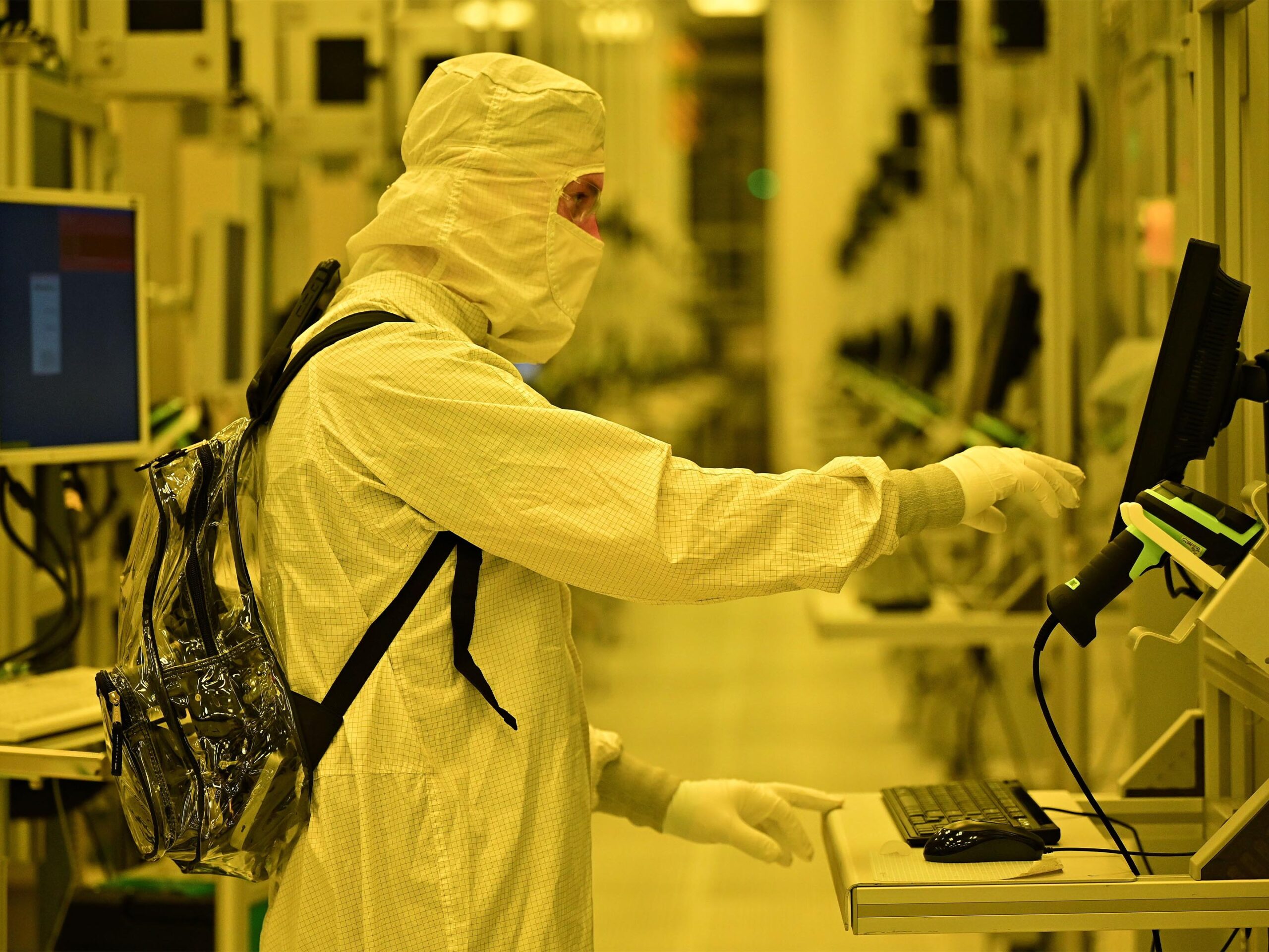 A worker completes tasks on a computer inside Intel's Fab 52.